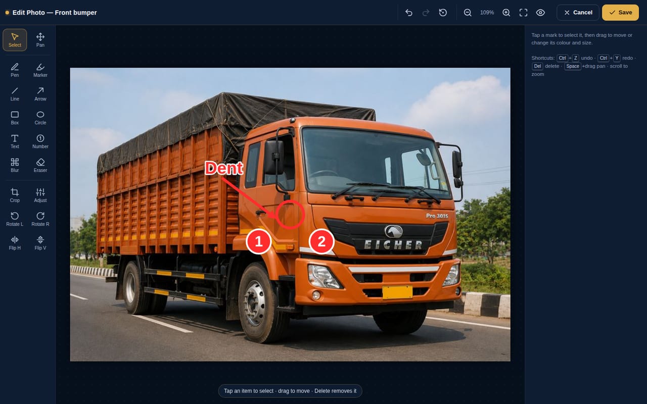 Photo editor with an arrow, a text label, numbered damage markers and a blurred number plate on a truck photo